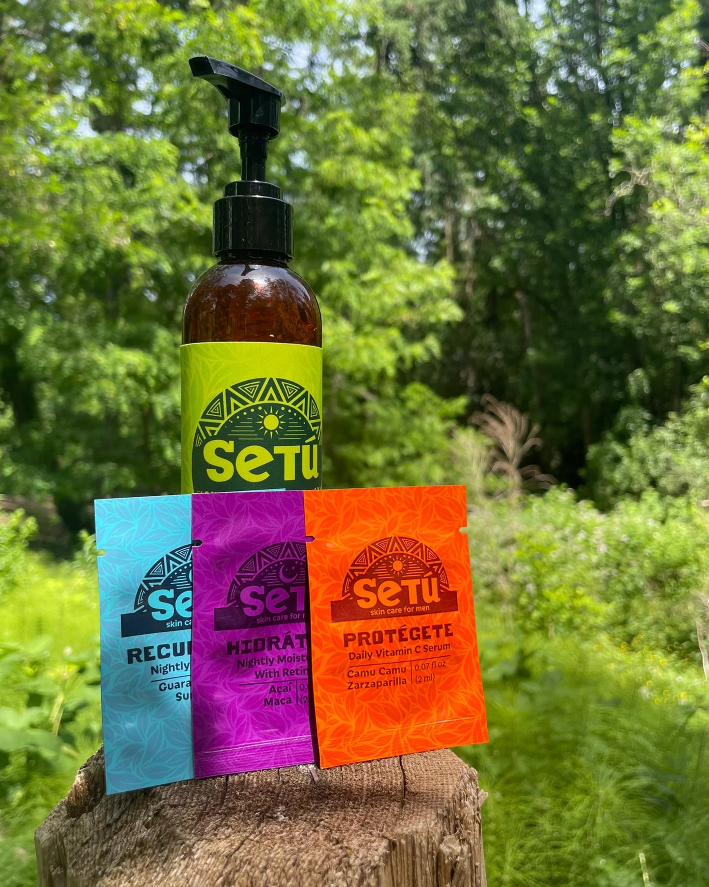 Setu skincare samples of mens vitamin c, moisturizer, and eye cream including a bottle and packets on a natural background