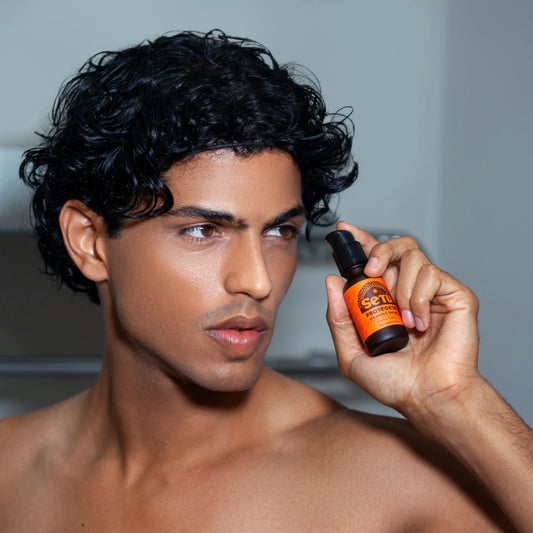 Man holding a bottle of Setu Skincare for Men 